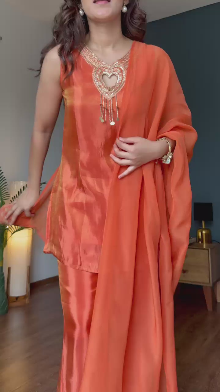 Heart-shaped gold zari embroidery at neckline